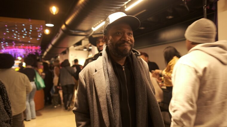 A guest smiling in the room during a community gathering