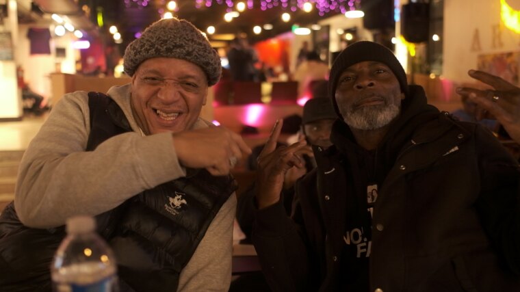 Two guests laughing together at a community gathering