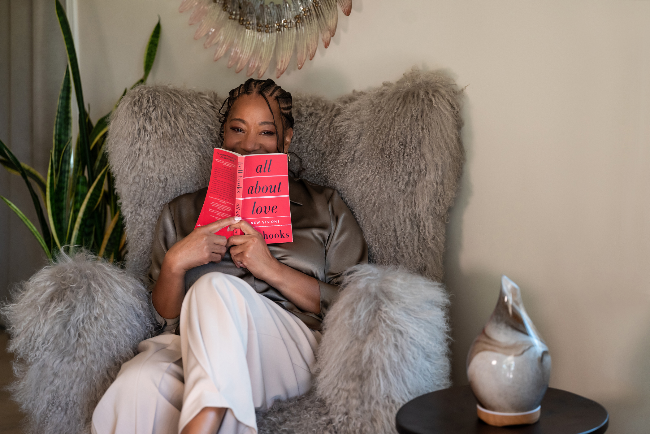 Lisane reading All About Love in her fur armchair