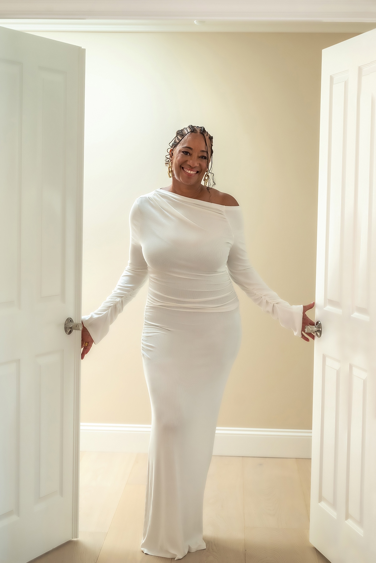 Lisane in a bright doorway, welcoming you in