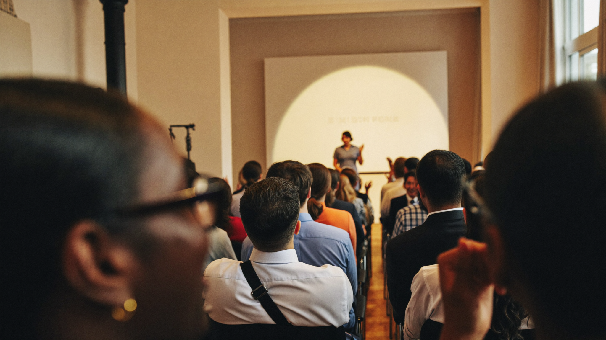An audience leaning in during Lisane's keynote
